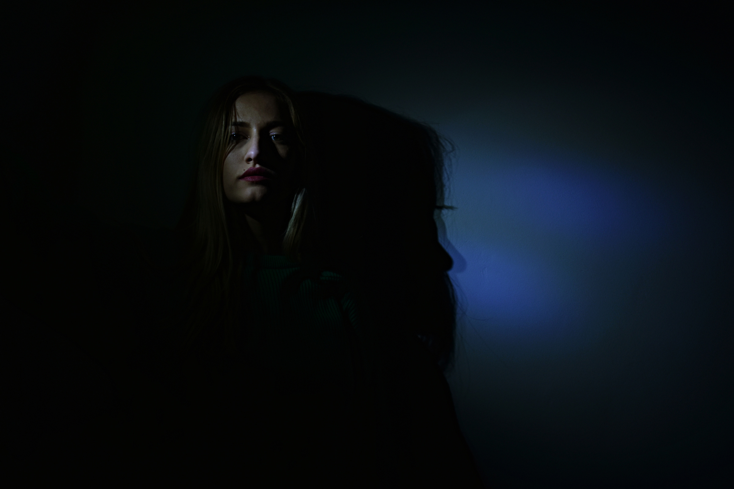 Photo of Woman in Dark Room